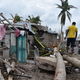 A young man walks on a palm tree in front of a destroyed house after Hurricane Matthew, in Croix Marche-a-Terre, in Southwest Haiti, on October 6, 2016. Hurricane Matthew has claimed at least 108 lives in Haiti, Interior Minister Francois Anick Joseph told AFP Thursday (Image: Getty)